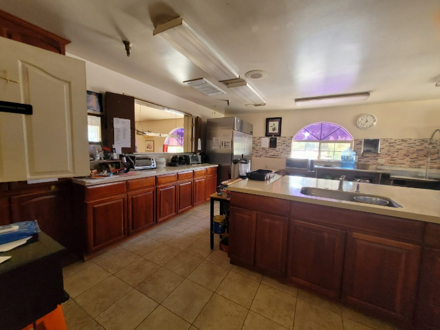 A large kitchen with wooden cabinets and counters.