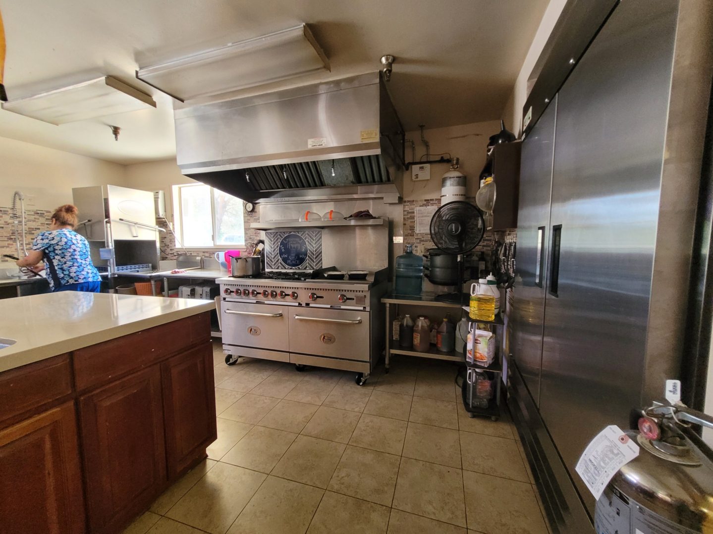 A kitchen with a large stove and many appliances.