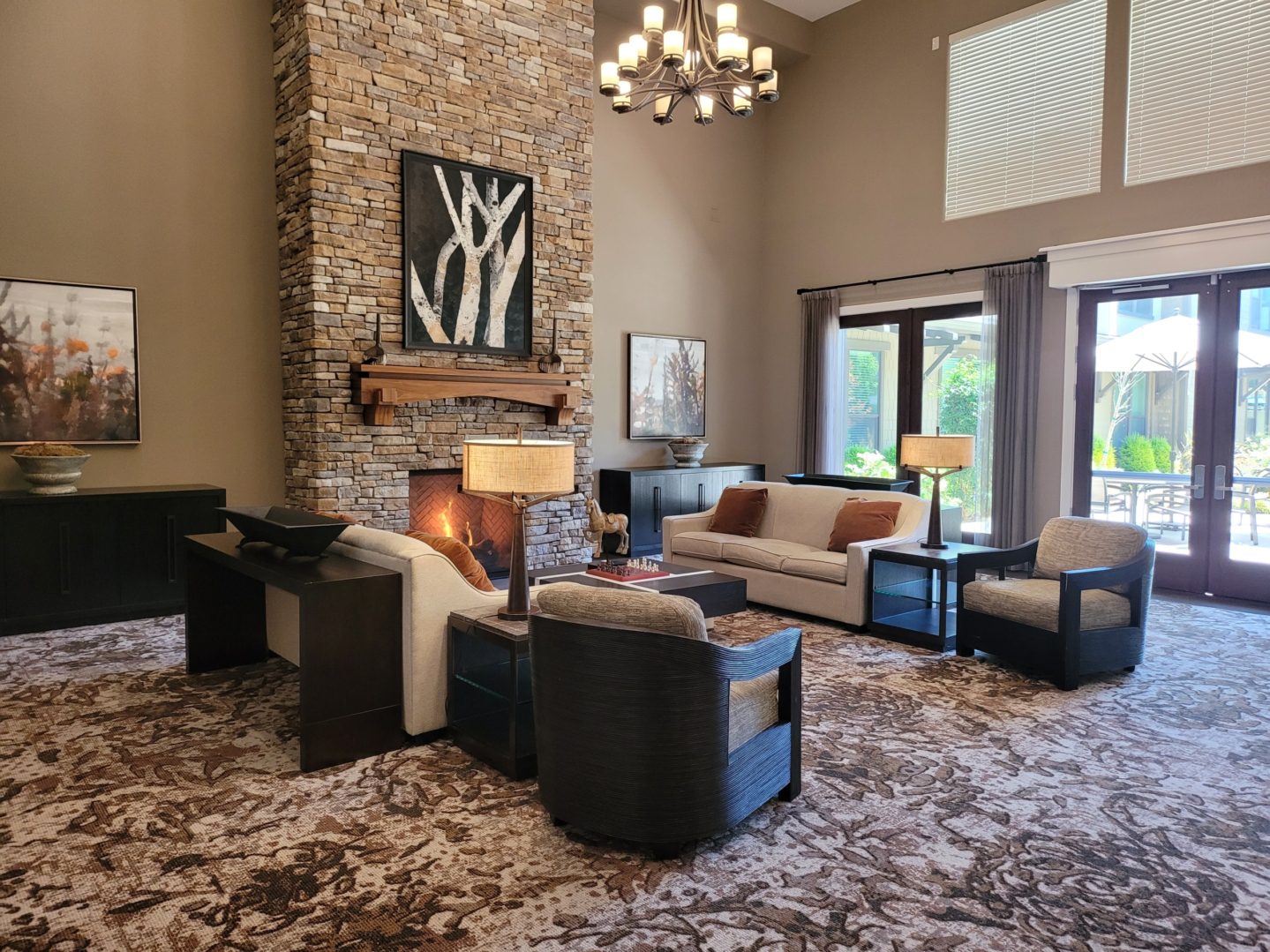 A living room with couches, chairs and tables.