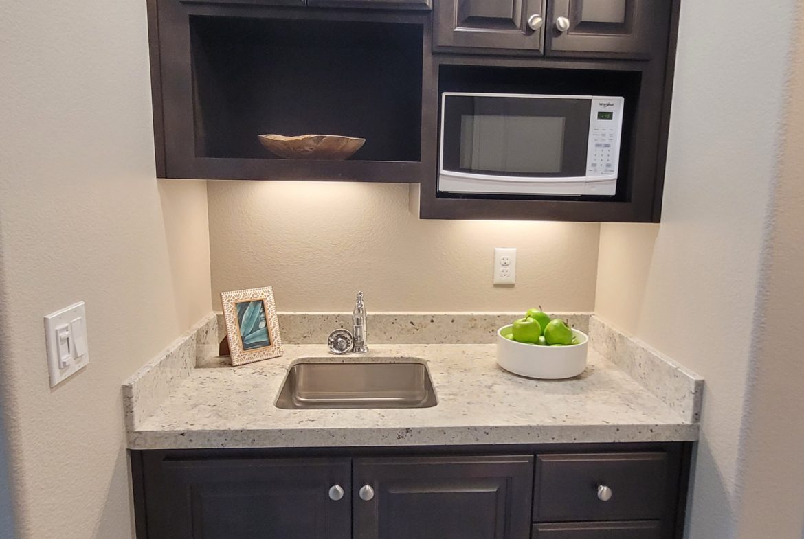 A kitchen with a sink and microwave in it