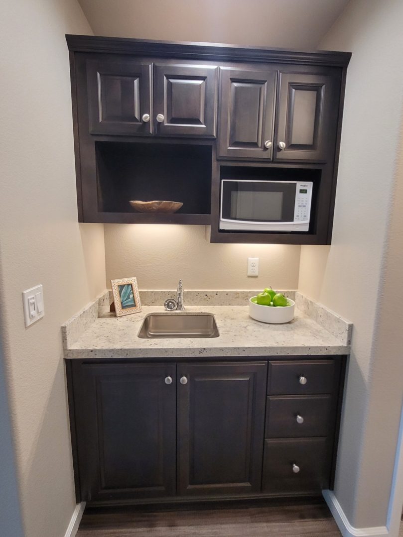 A kitchen with a sink and microwave in it