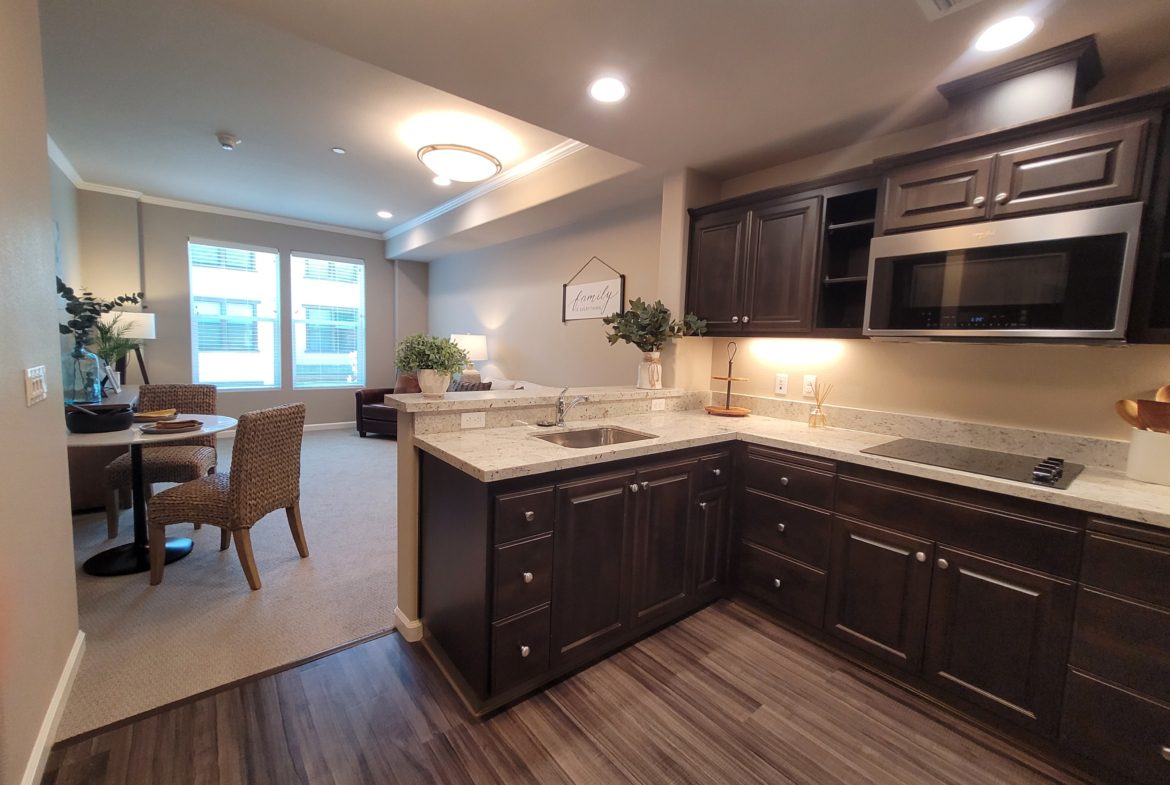 A kitchen with a dining room table and chairs.