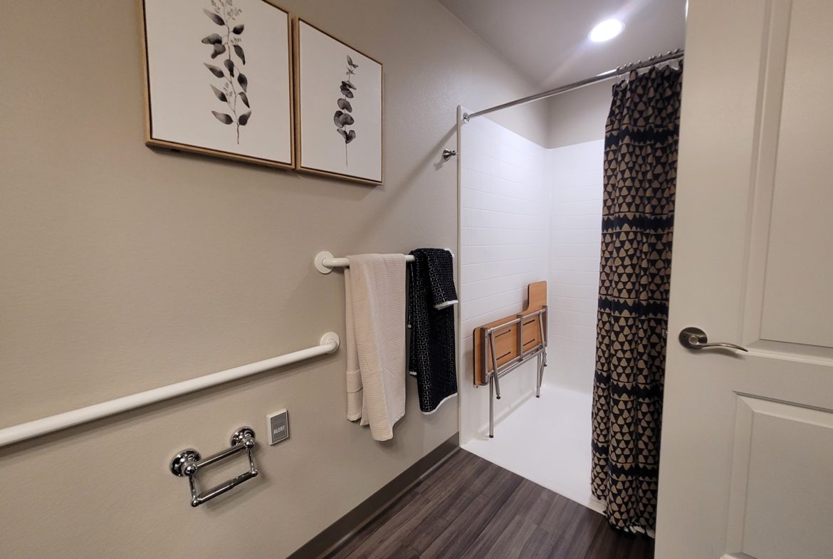 A bathroom with a shower and toilet in it