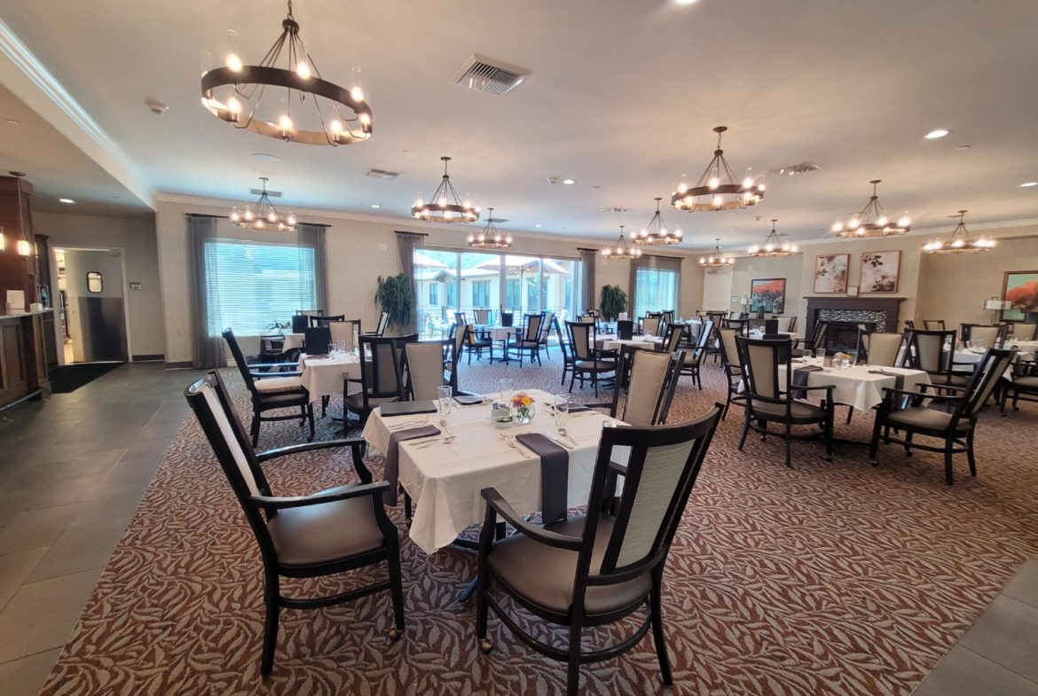 A large room with many tables and chairs.