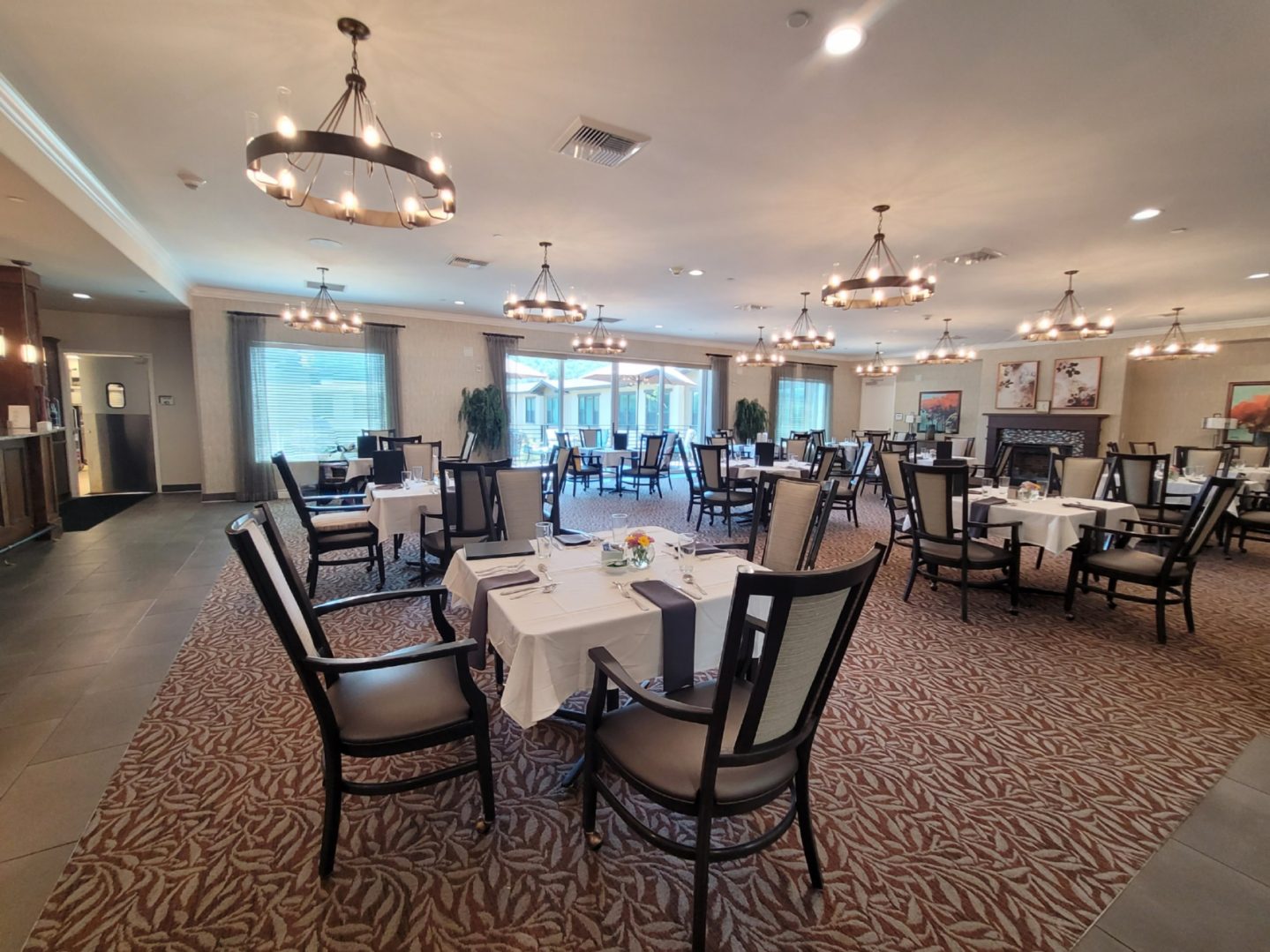 A large room with many tables and chairs.