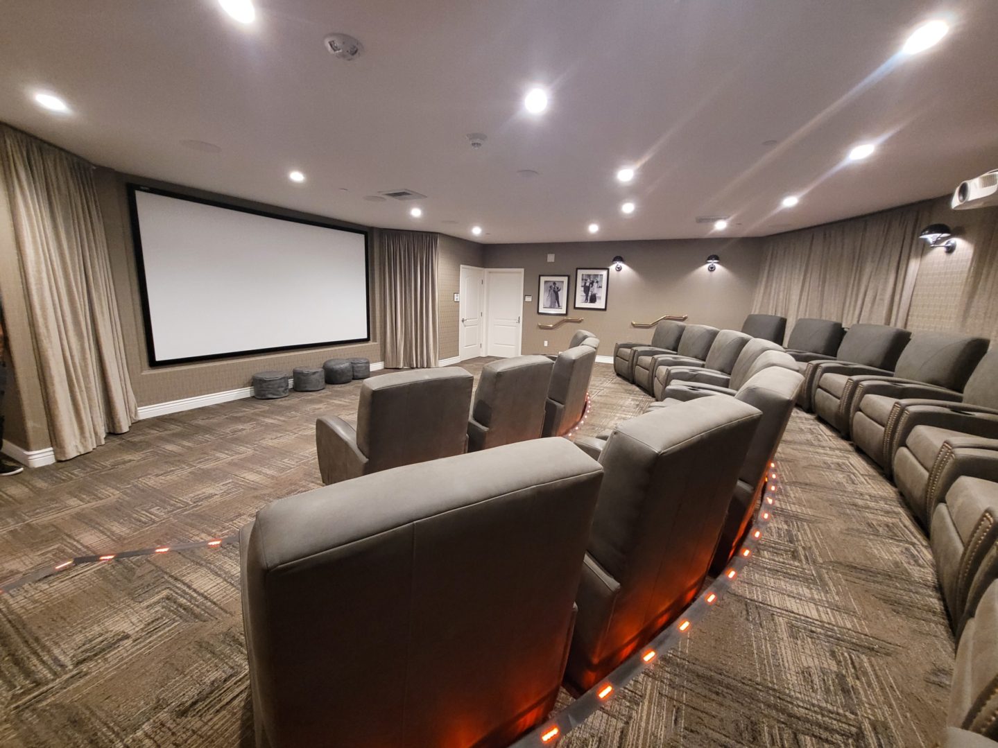 A large room with many chairs and a projector screen.