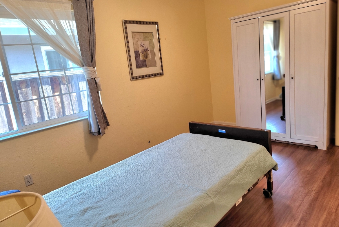 A bed room with a white bed and yellow walls