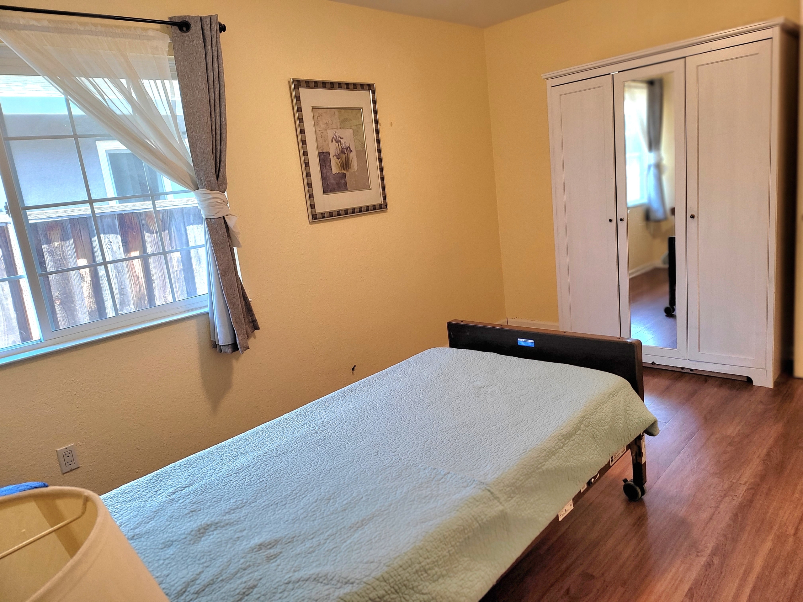 A bed room with a white bed and yellow walls