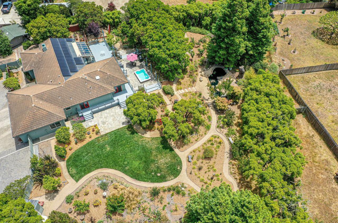 A bird 's eye view of a house with trees and grass.