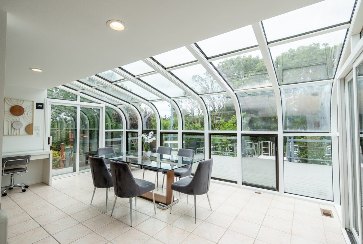 A dining room with glass table and chairs