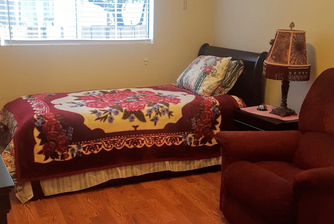 Cozy bedroom with bed and armchair.
