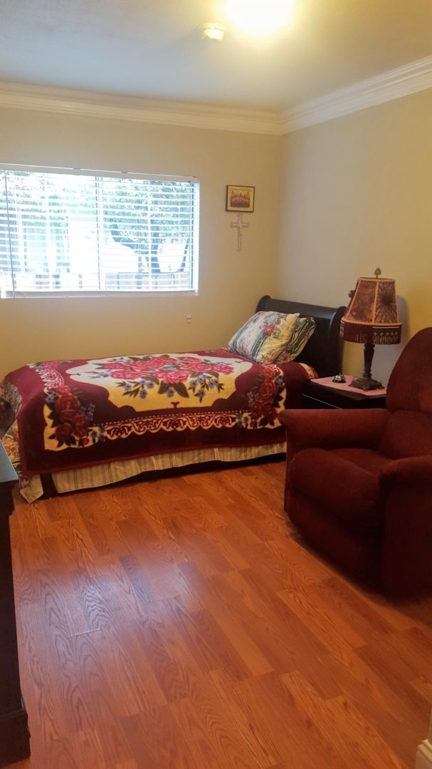 Cozy bedroom with bed and armchair.