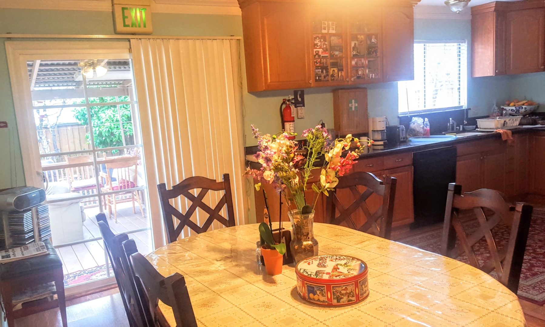 Kitchen with table, flowers, and outdoor view.
