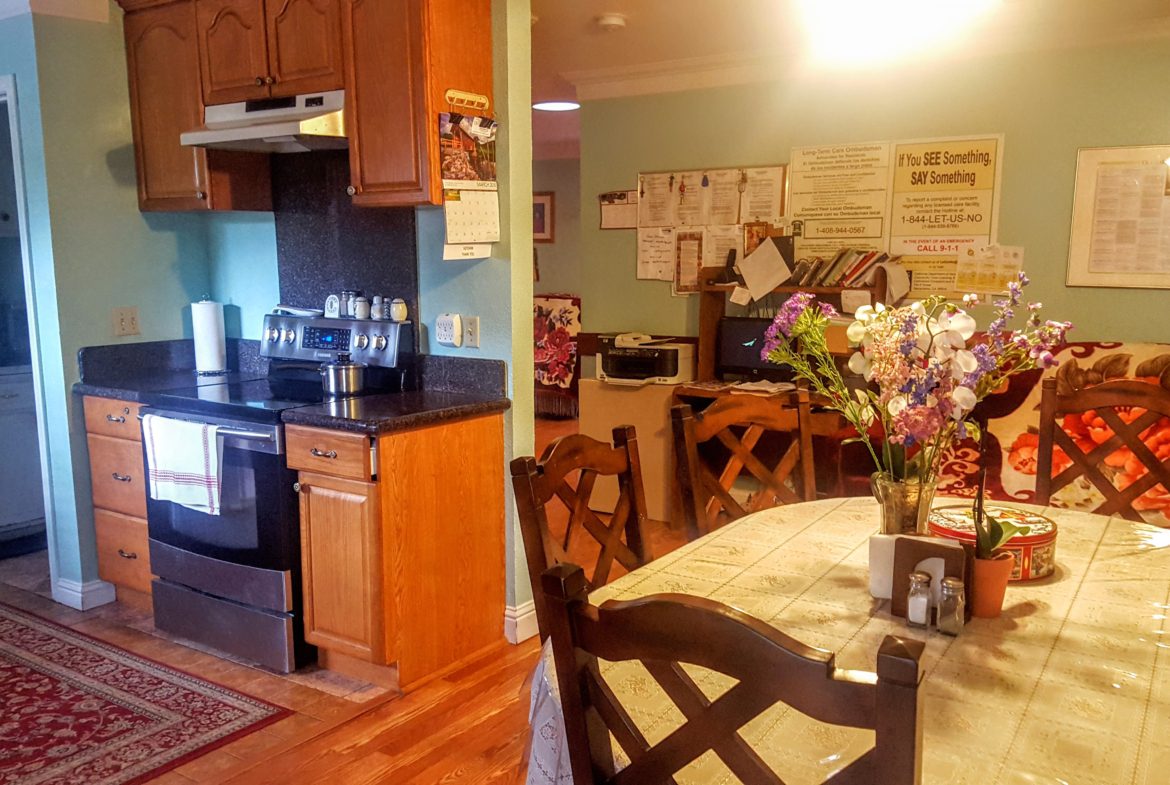 Cozy kitchen and dining area with flowers.