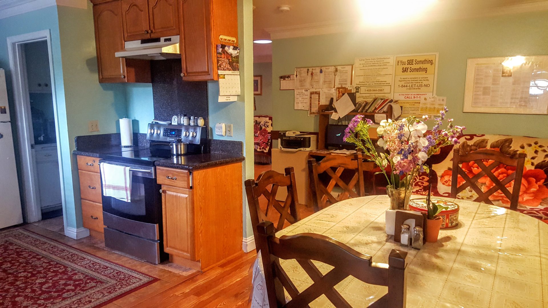 Cozy kitchen and dining area with flowers.