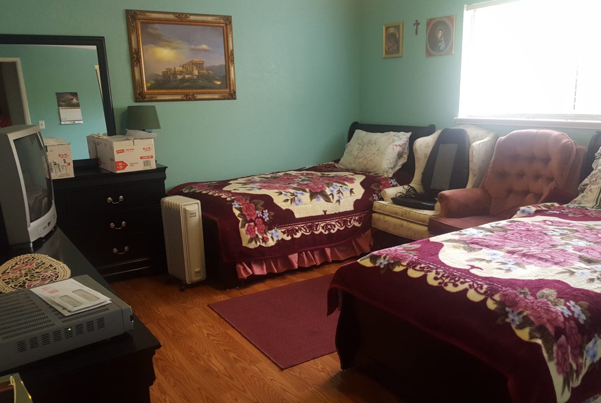 Cozy bedroom with two beds and TV.