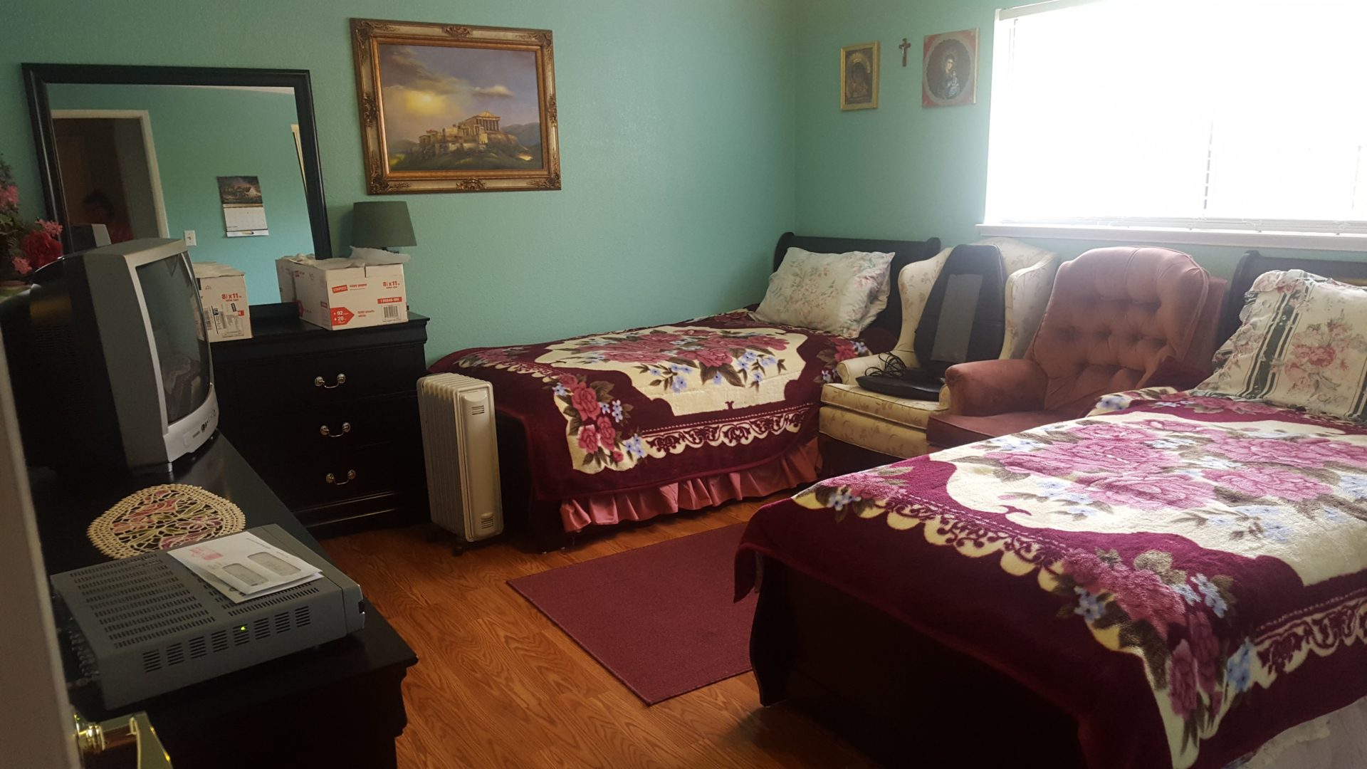 Cozy bedroom with two beds and TV.