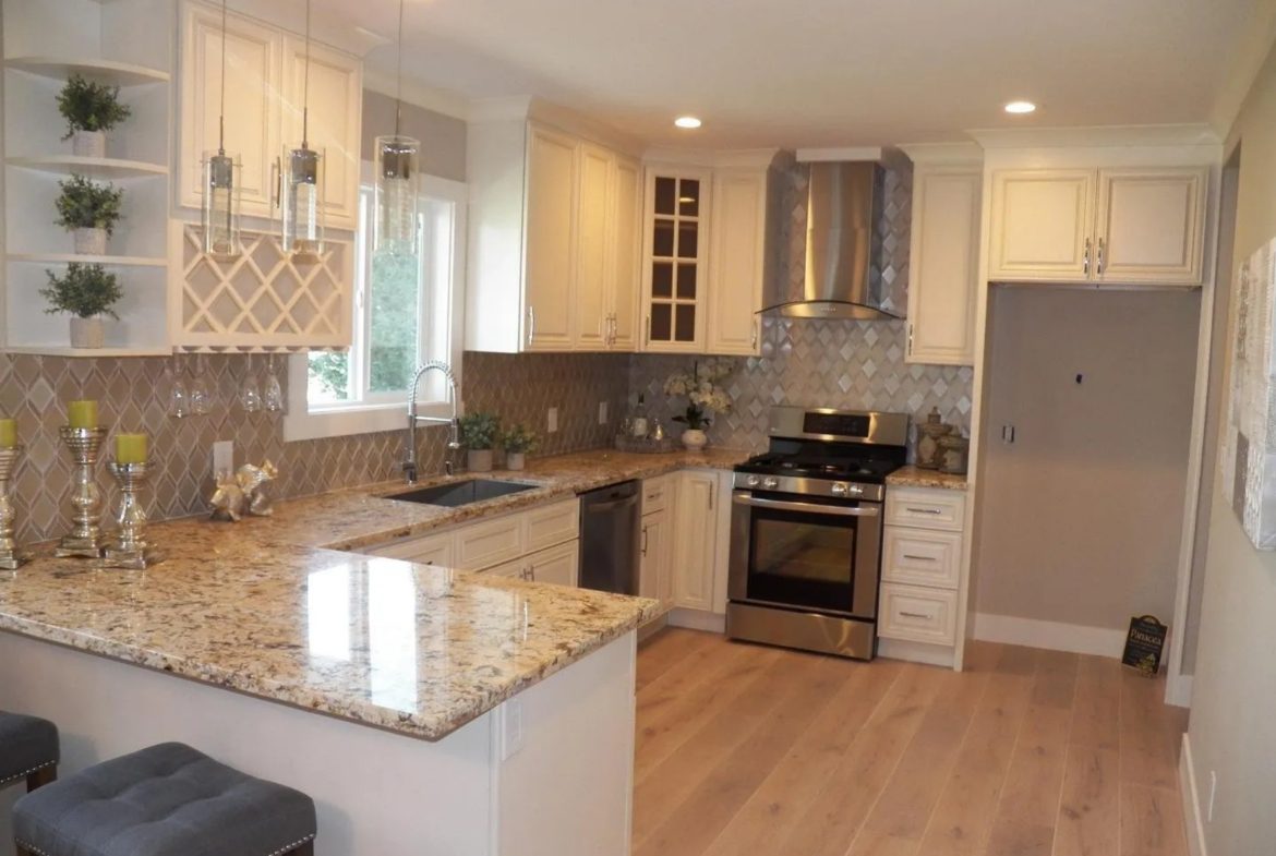 Modern kitchen with granite countertops and appliances.