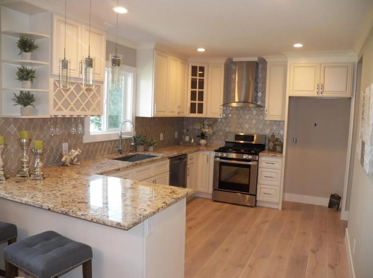 Modern kitchen with granite countertops and appliances.