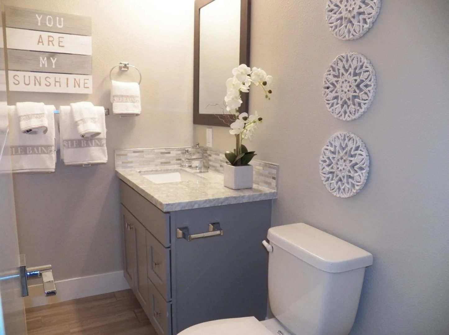 Small bathroom with modern decor and flowers.