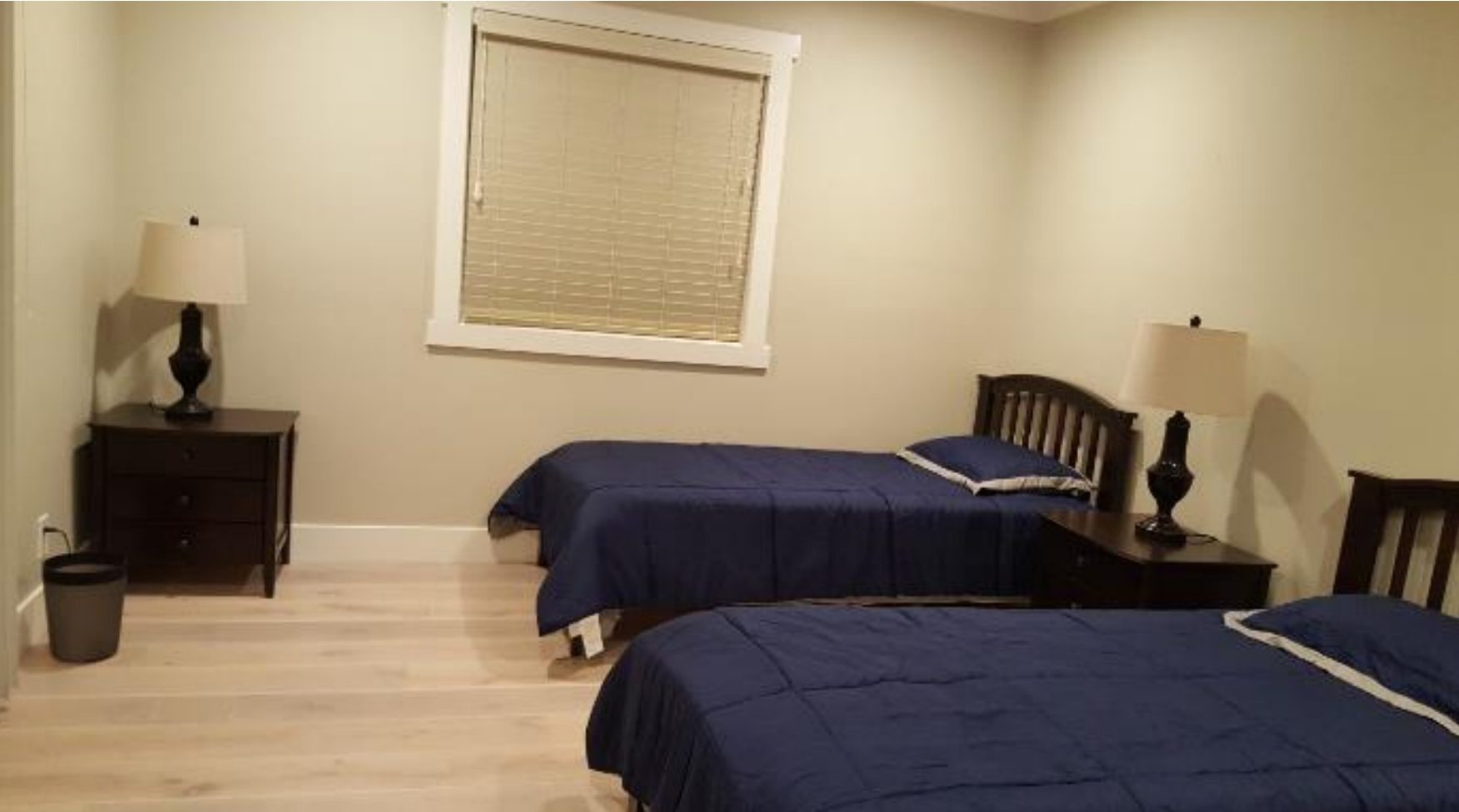 Bedroom with two beds and nightstands.