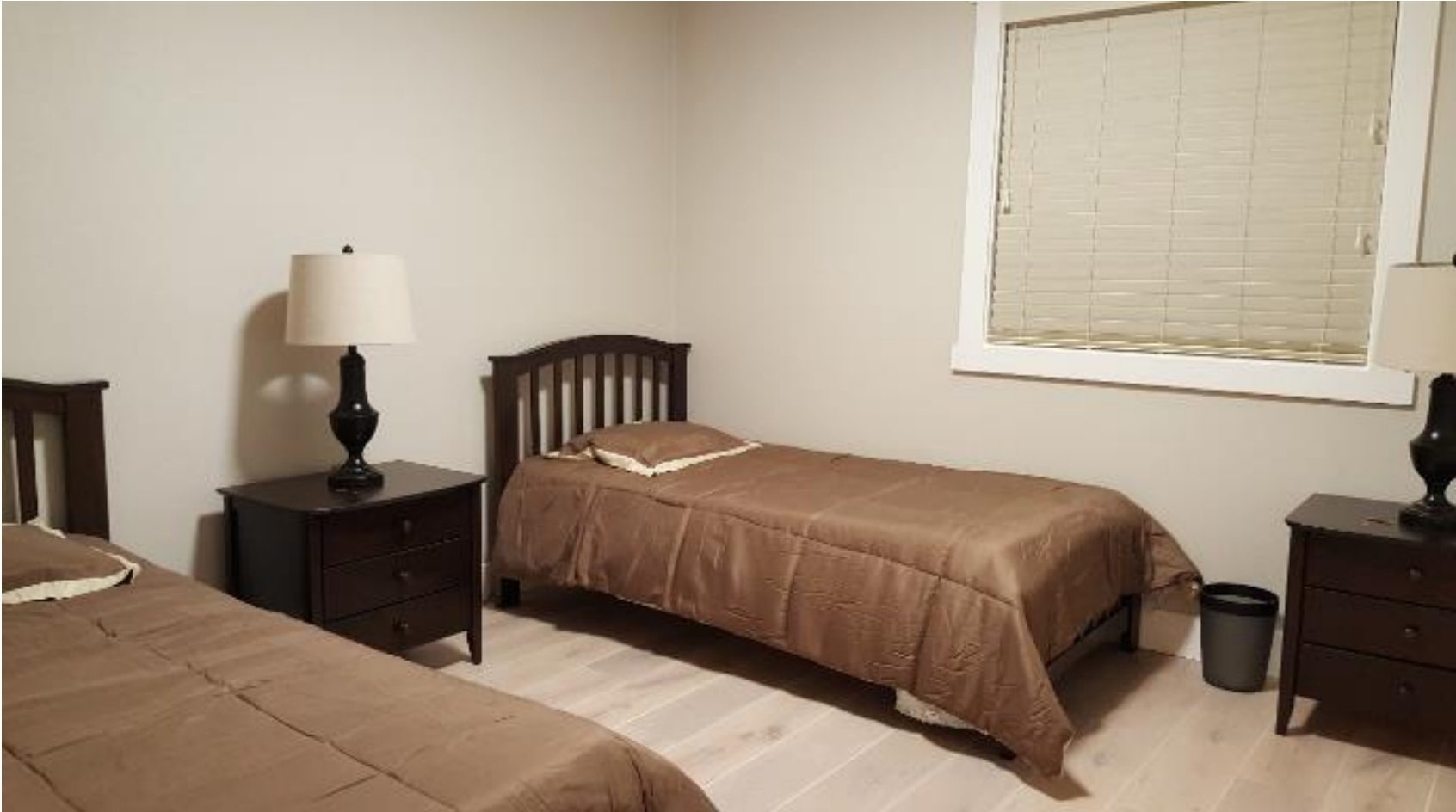 Two twin beds in a simple bedroom.