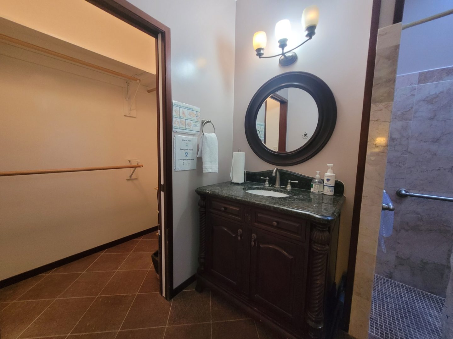 Bathroom vanity with mirror and closet entrance.