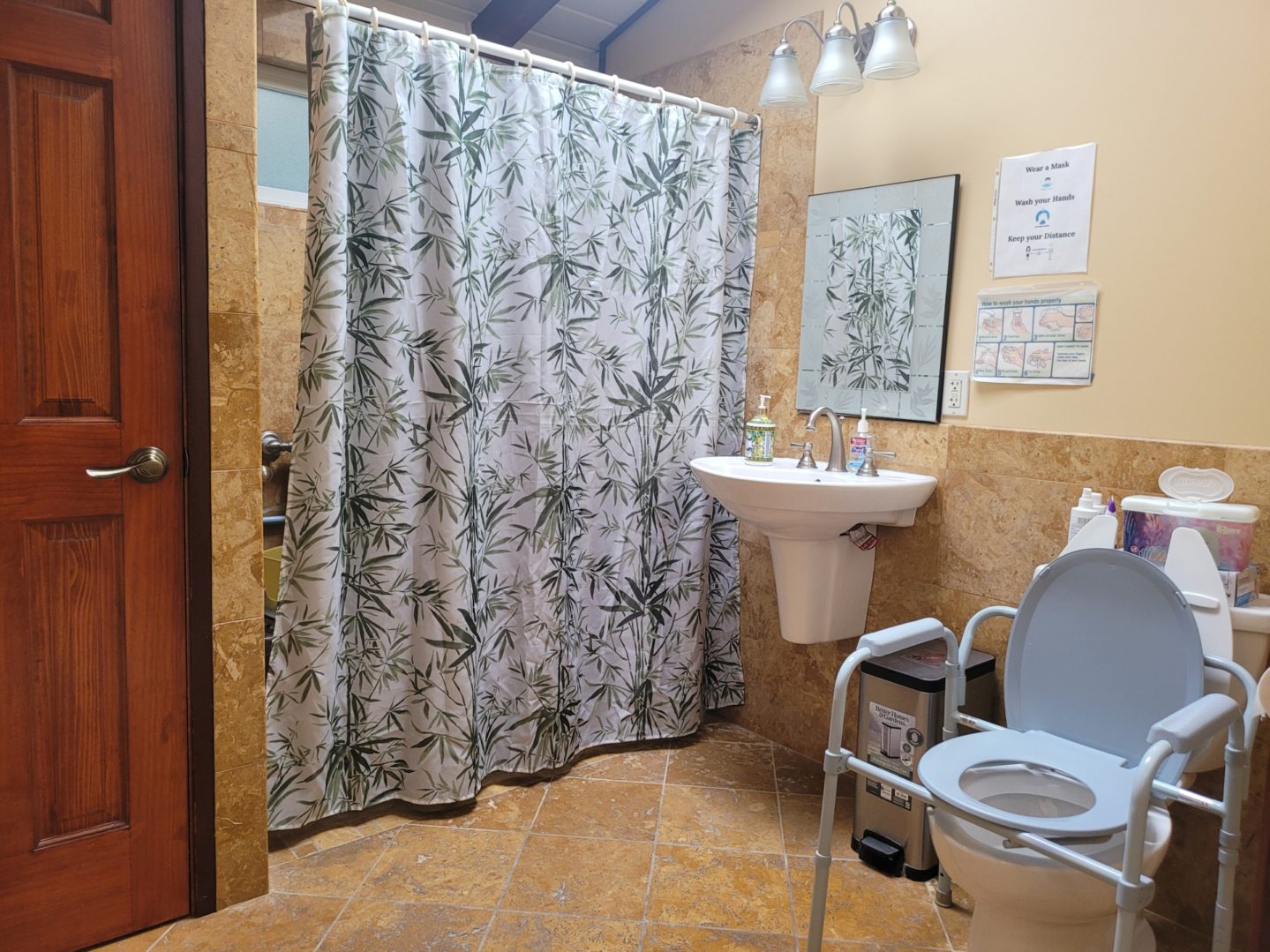 Accessible bathroom with shower and toilet chair.