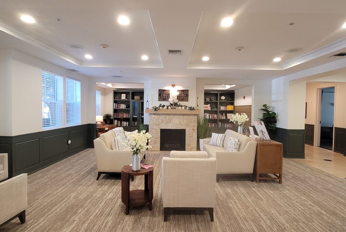 Modern lounge with cozy seating and fireplace.