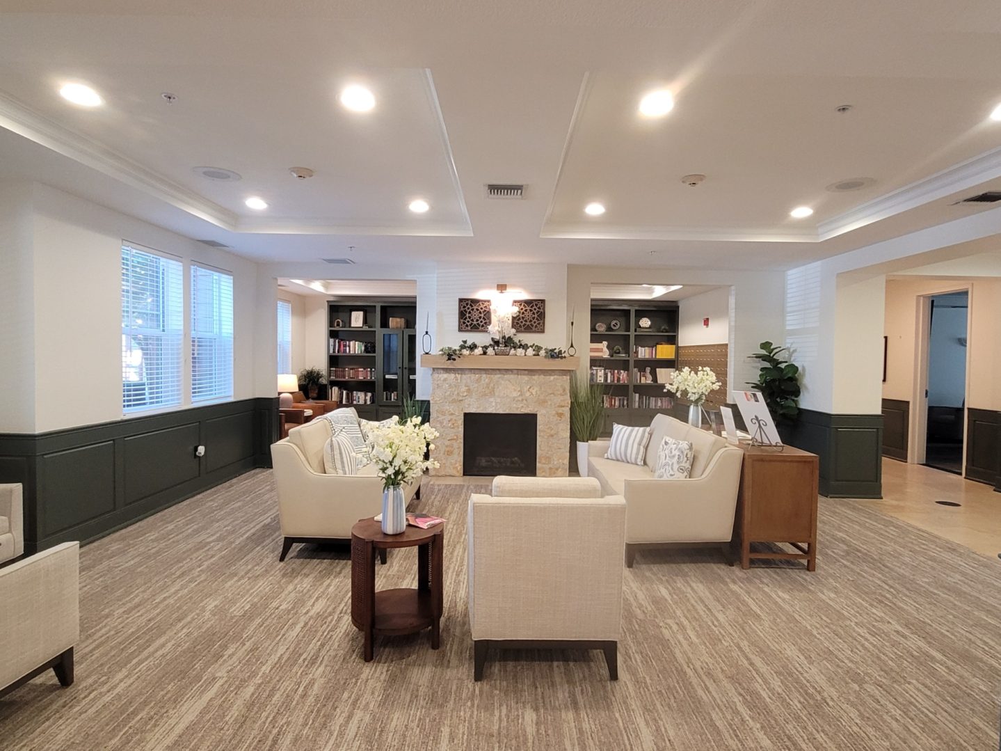 Modern lounge with cozy seating and fireplace.
