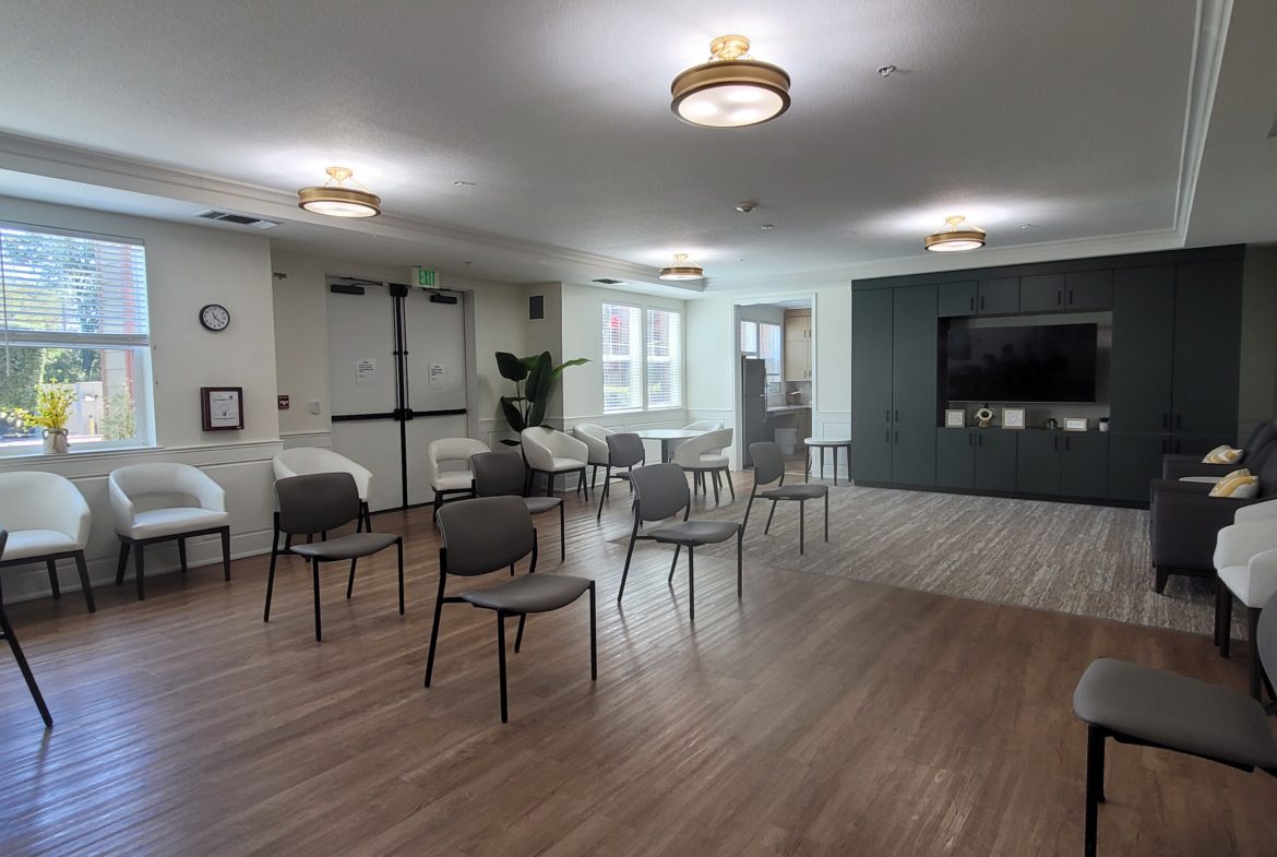 Spacious room with chairs and television.