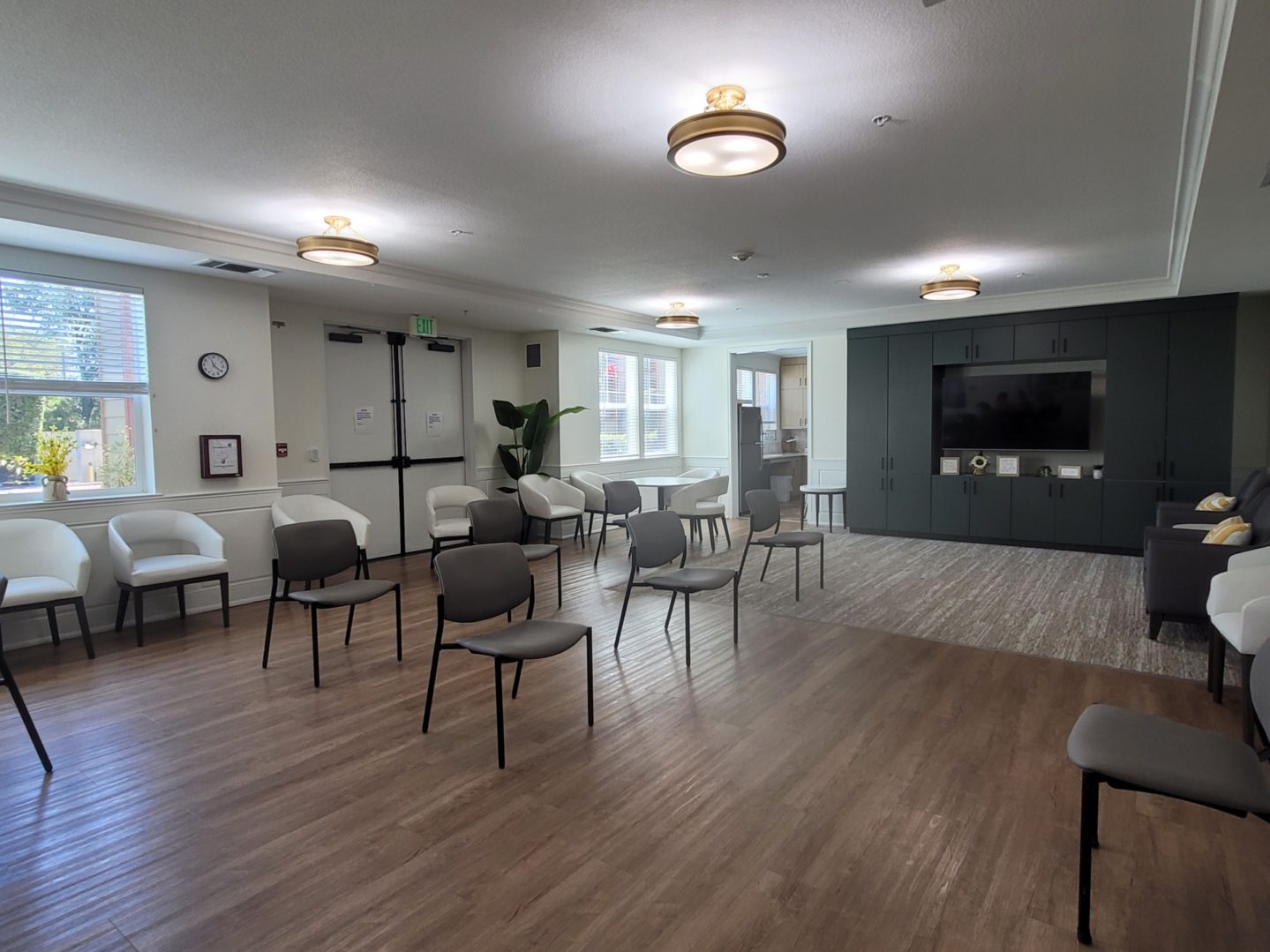 Spacious room with chairs and television.
