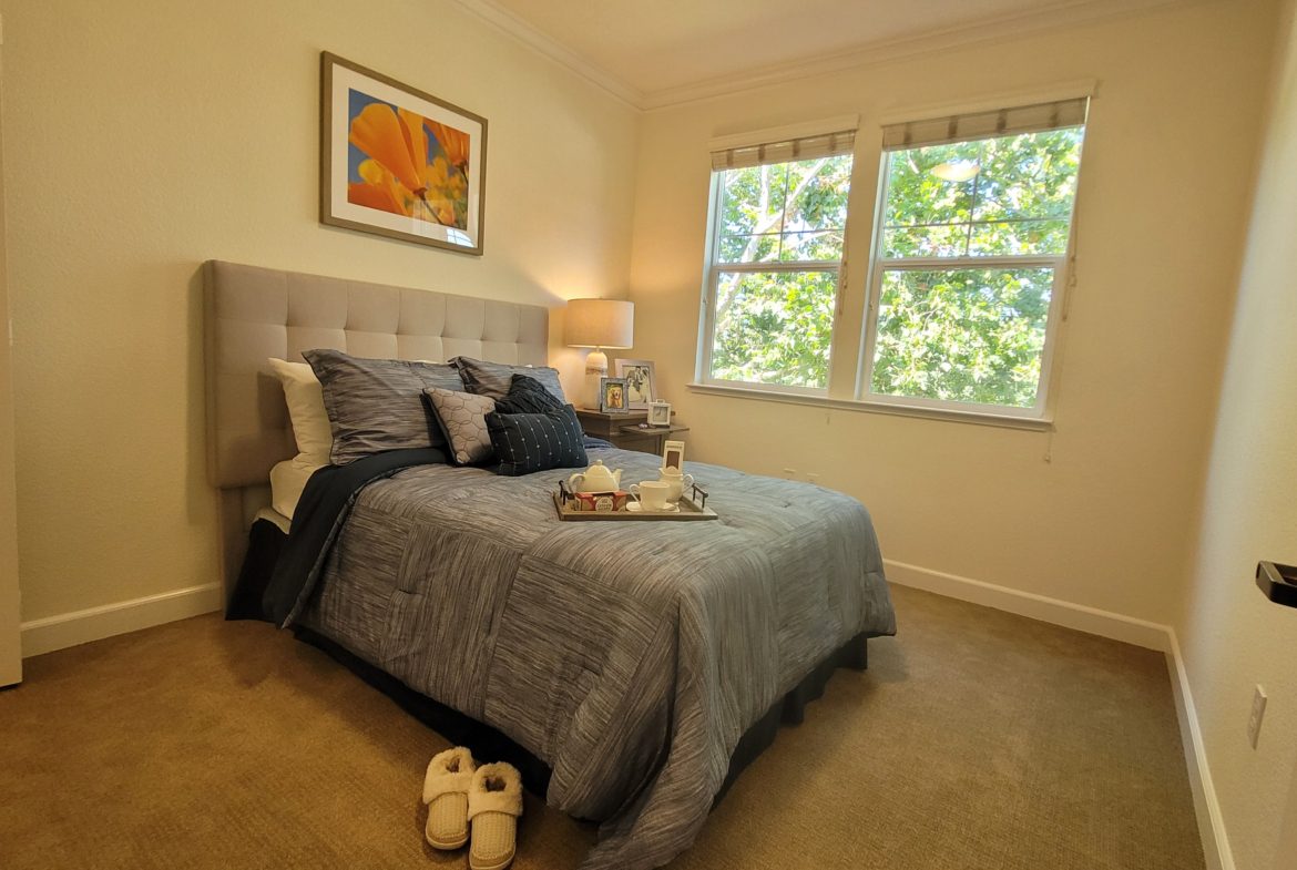 Cozy bedroom with a neatly made bed.
