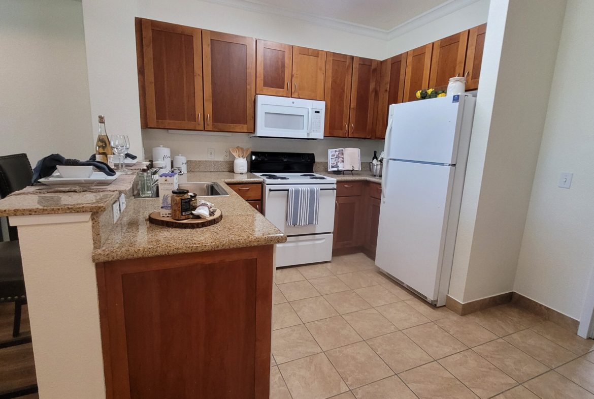Modern kitchen with wooden cabinets and appliances.