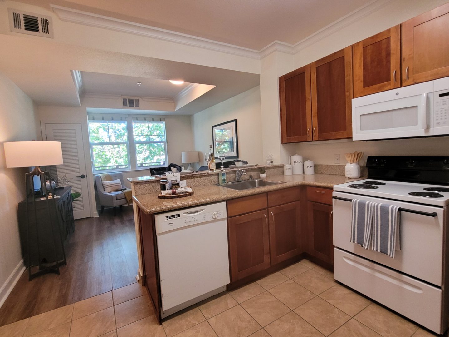 Modern kitchen and living area with appliances.