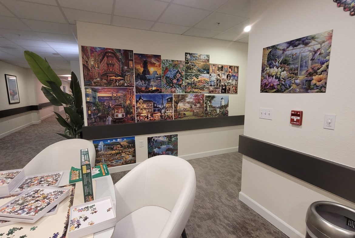 Room with puzzle artwork on walls.