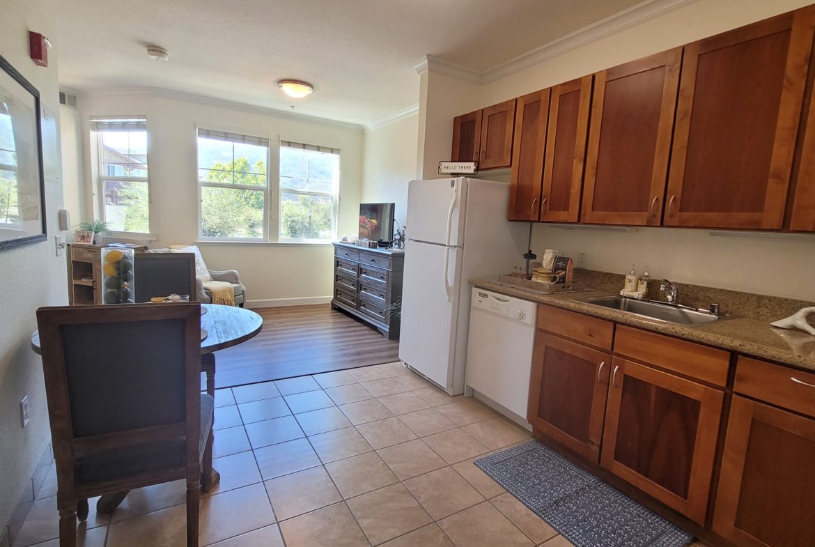 Cozy kitchen and dining area with sunlight.