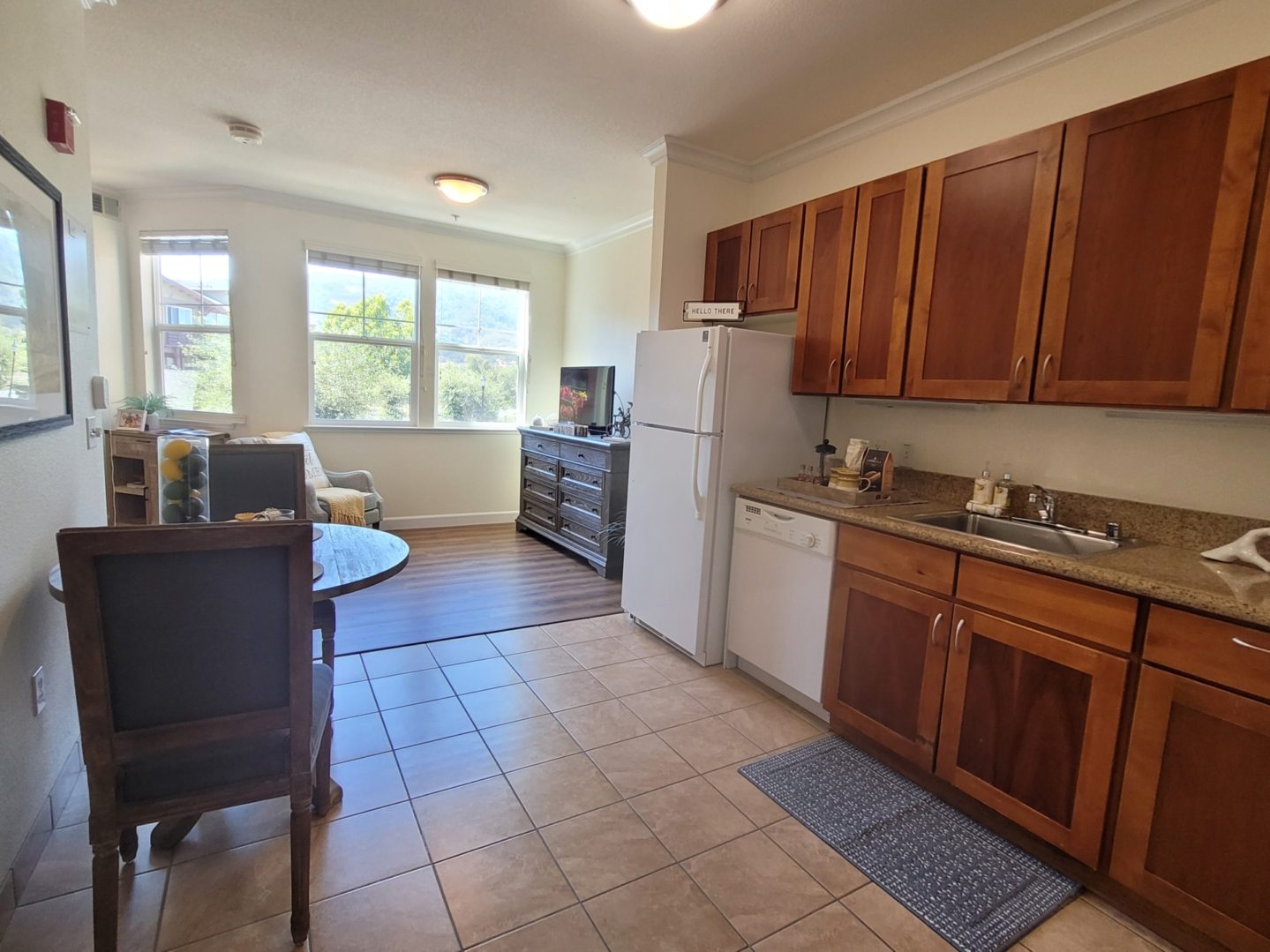 Cozy kitchen and dining area with sunlight.