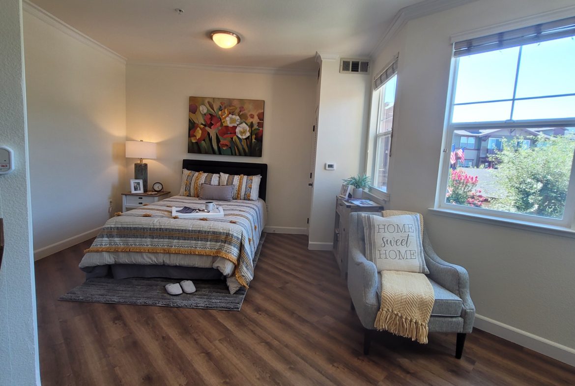 Cozy bedroom with bed and armchair.