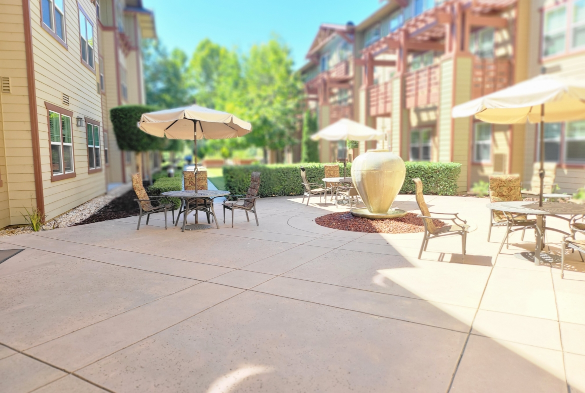 Outdoor patio with tables and umbrellas.