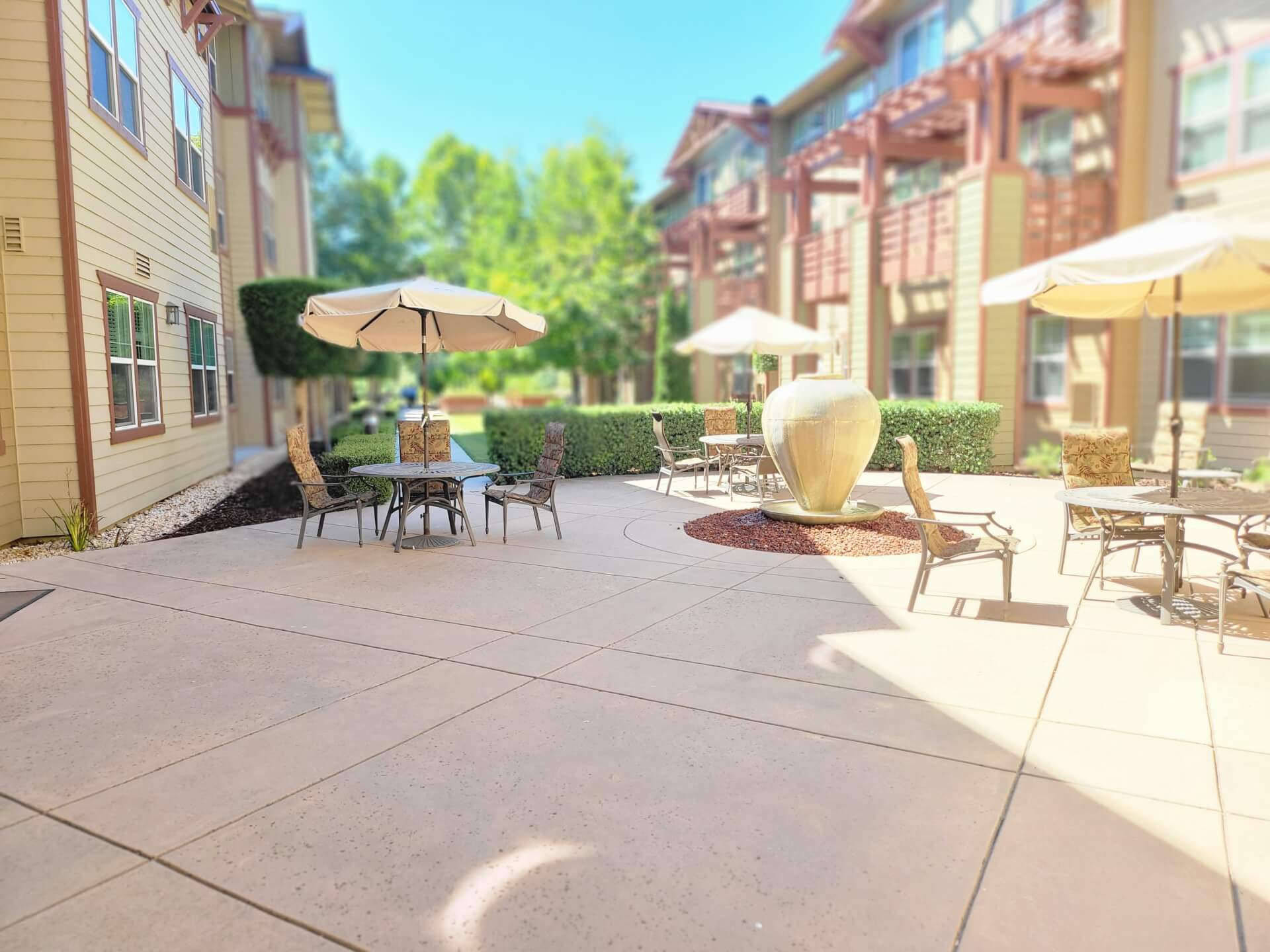 Outdoor patio with tables and umbrellas.
