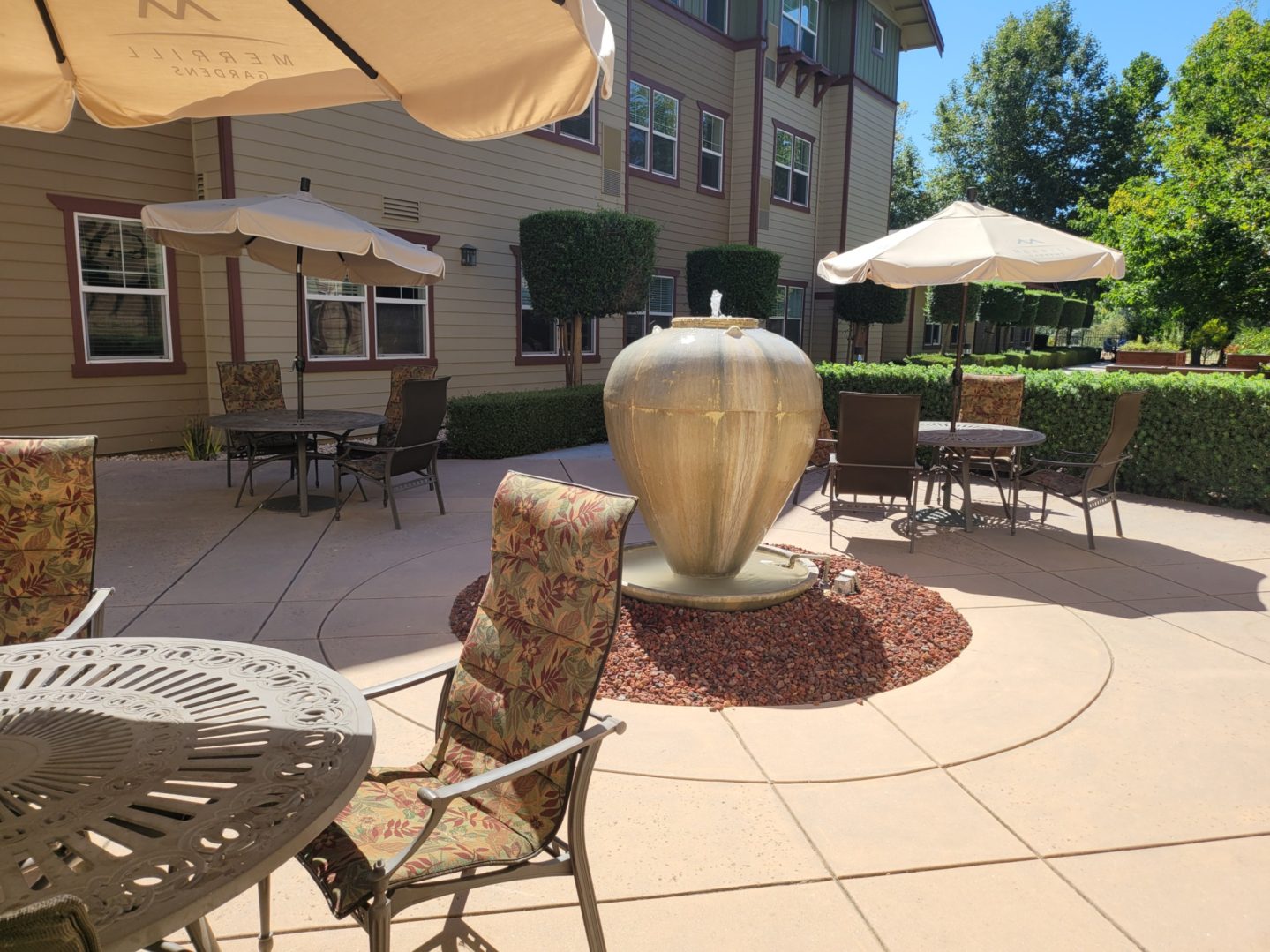 Outdoor patio with fountain and seating area.