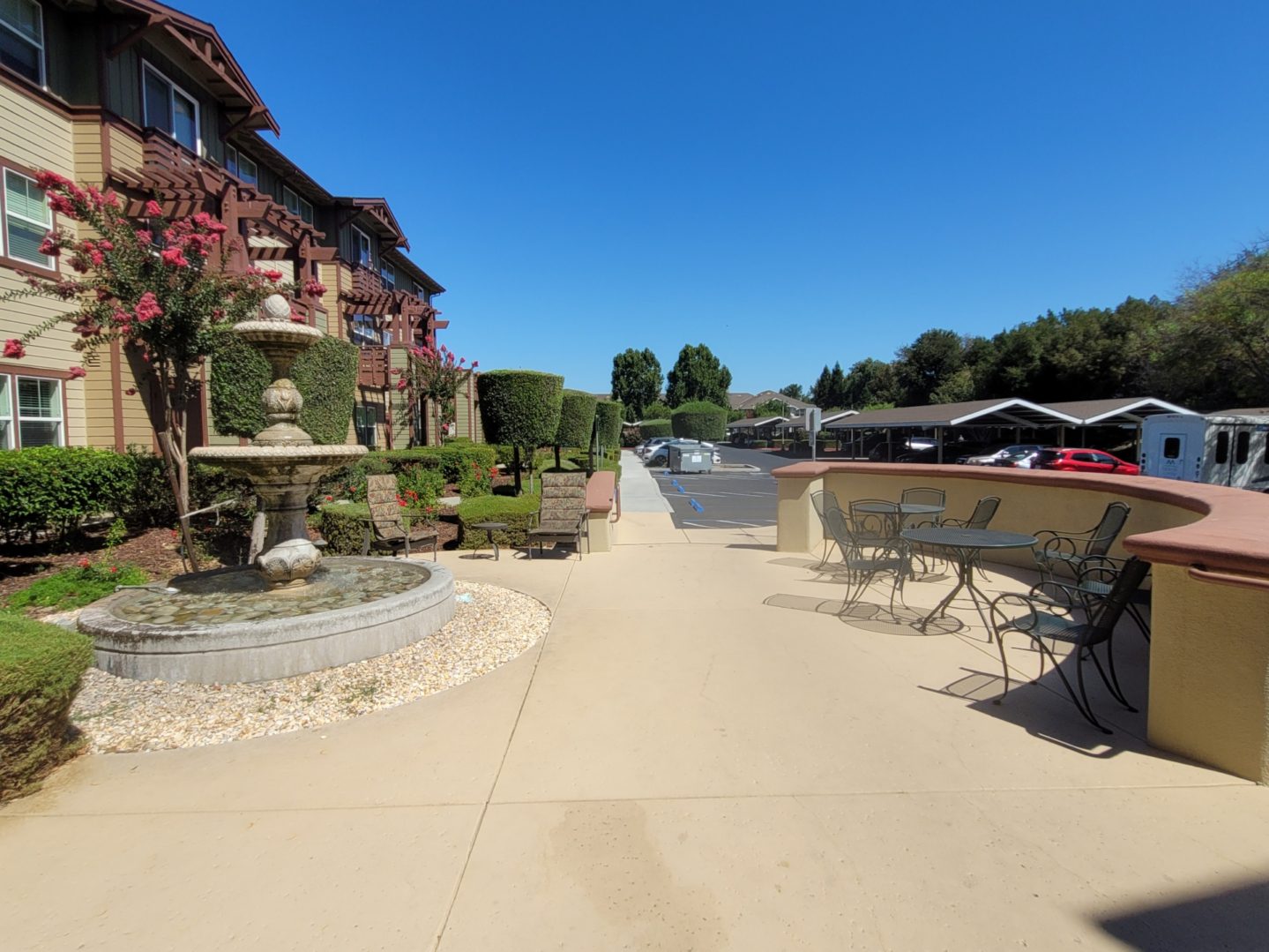 Outdoor patio with fountain and seating area.