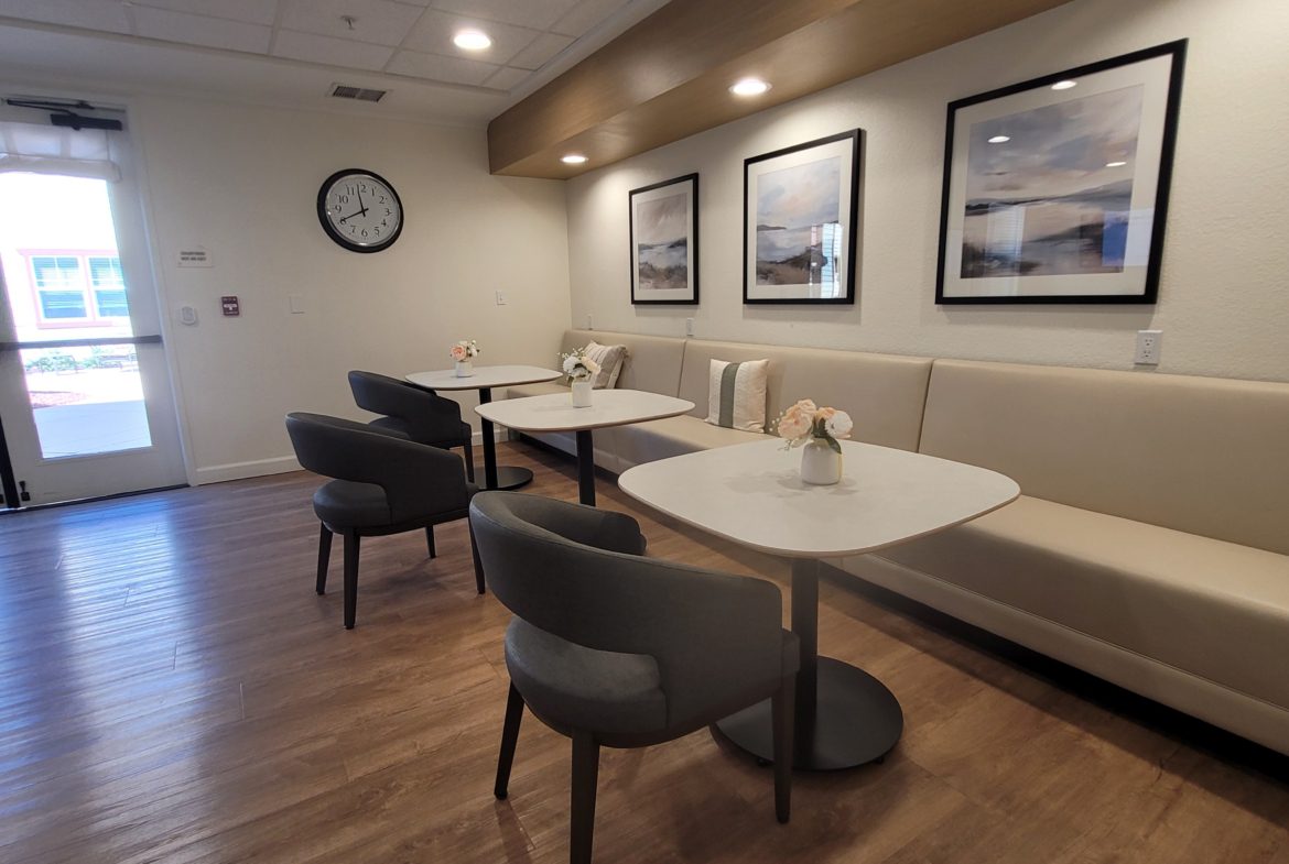 Modern cafe interior with tables and chairs.