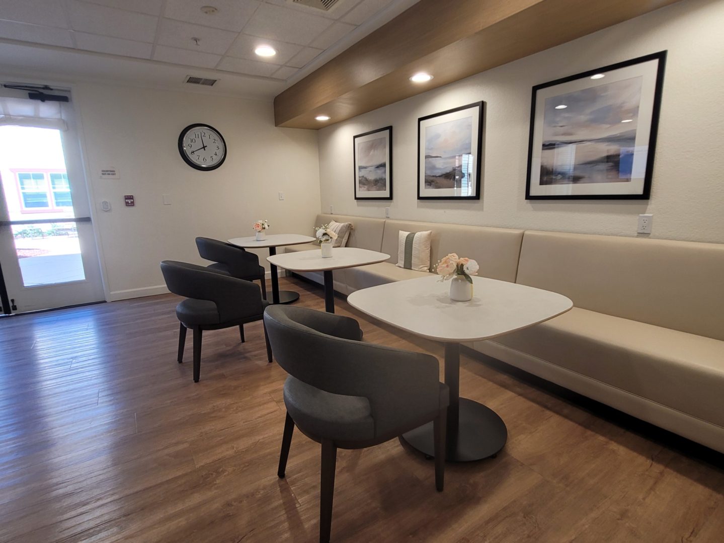 Modern cafe interior with tables and chairs.