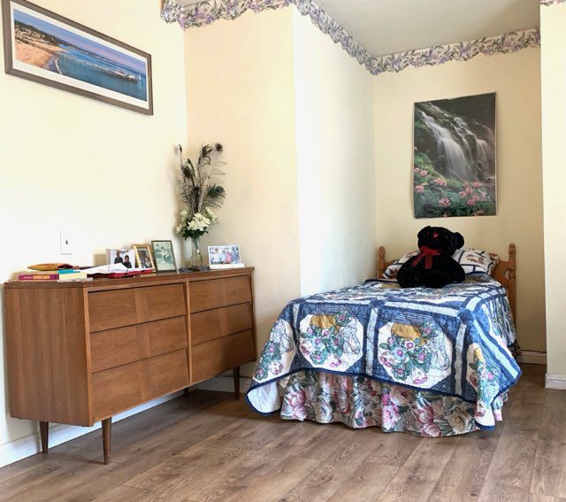 Cozy bedroom with dresser and bed.