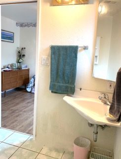 Bathroom with towel, sink, and mirror.