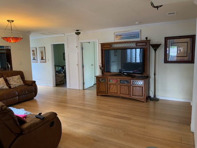 Spacious living room with wooden flooring.