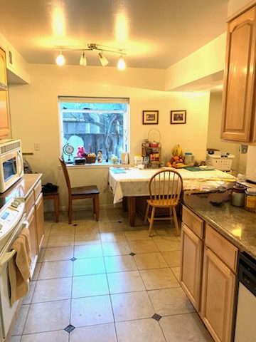 Cozy kitchen with dining table and chairs.