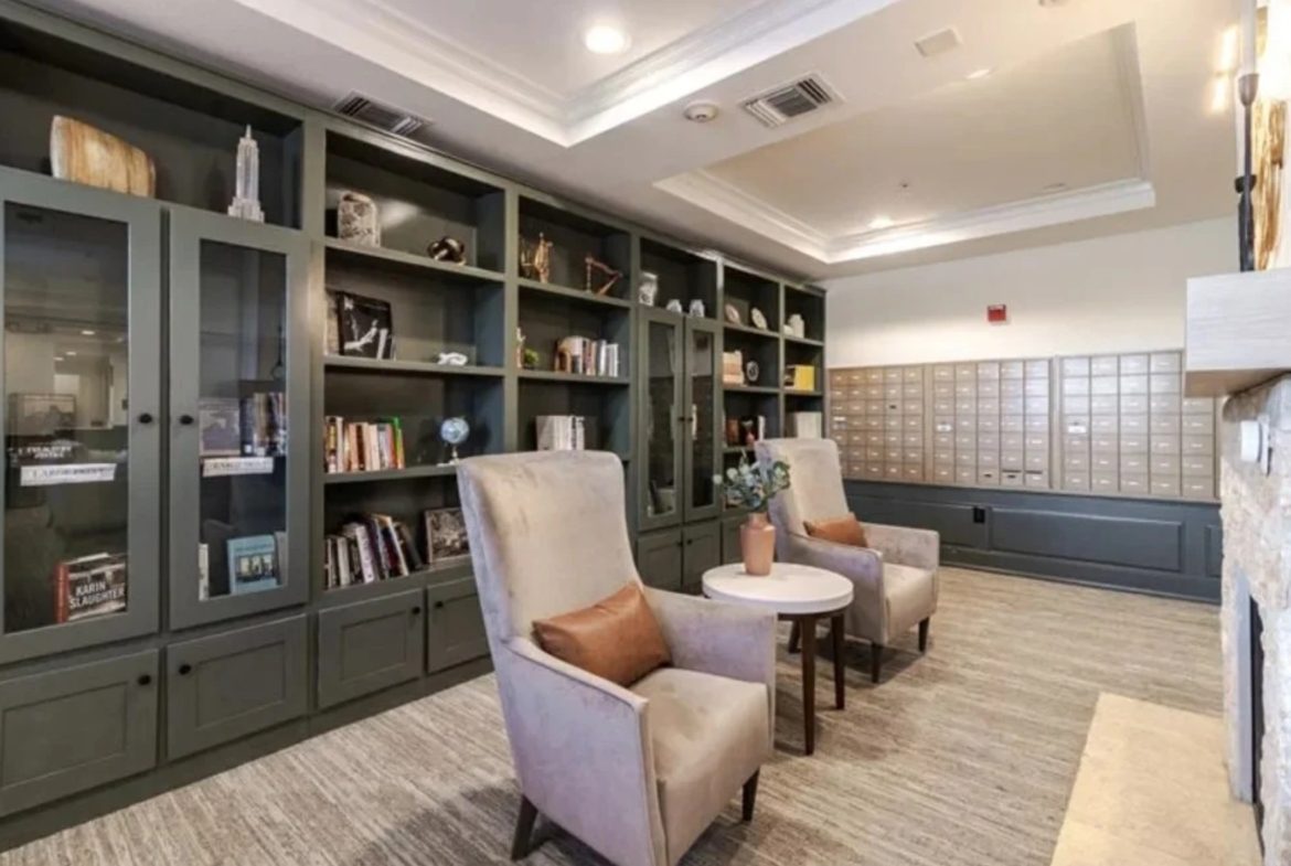 Library lounge with chairs and bookshelves.